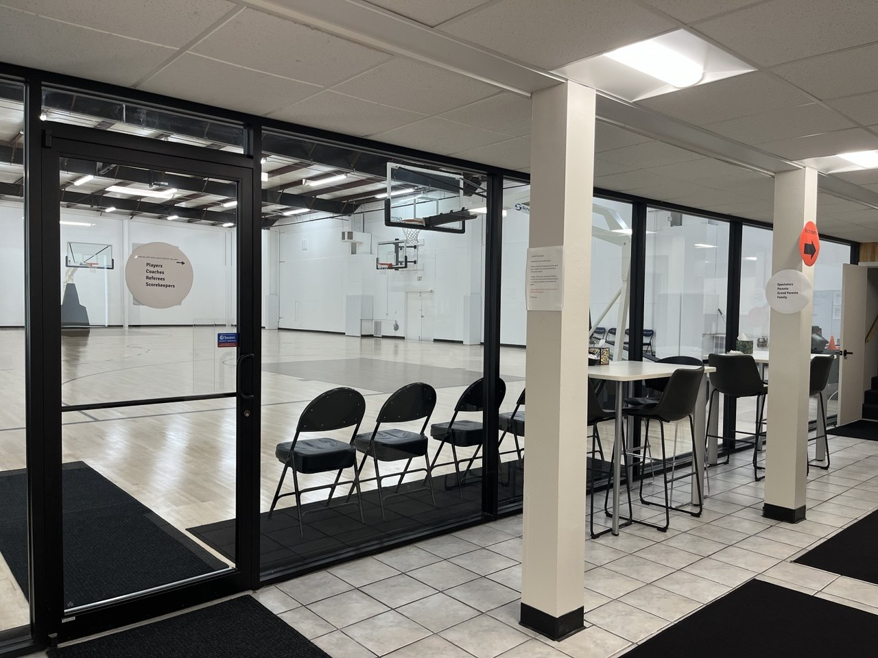 Lobby seating with glass views into the practice courts